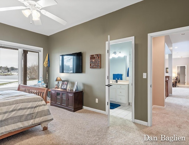 bedroom featuring ceiling fan, ensuite bath, and light carpet