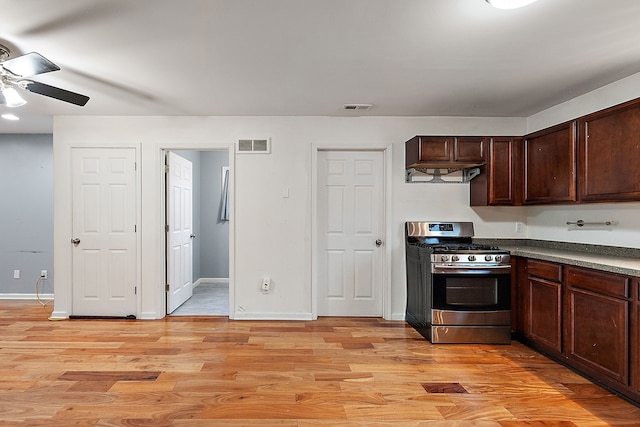 kitchen with ceiling fan, dark brown cabinetry, stainless steel range with gas stovetop, and light hardwood / wood-style floors