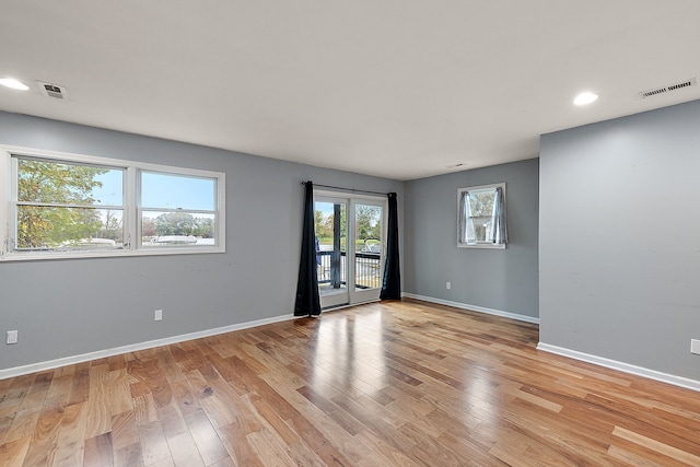 spare room with light hardwood / wood-style flooring