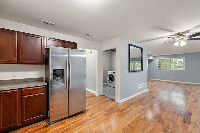 kitchen featuring washer / clothes dryer, stainless steel refrigerator with ice dispenser, ceiling fan, and light hardwood / wood-style floors