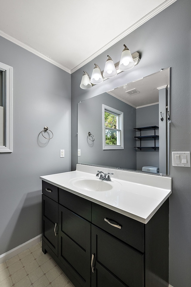 bathroom with vanity, crown molding, and toilet