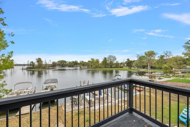 deck with a water view and a lawn