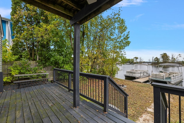 wooden terrace with a water view and a boat dock