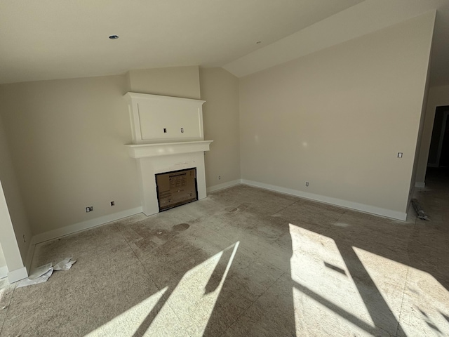 unfurnished living room featuring lofted ceiling