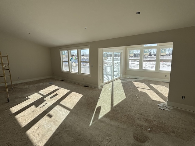 unfurnished living room featuring a wealth of natural light