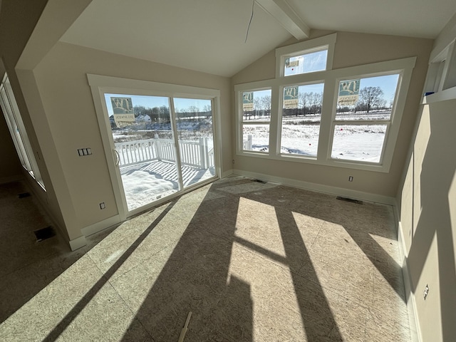 unfurnished sunroom with lofted ceiling with beams and a healthy amount of sunlight