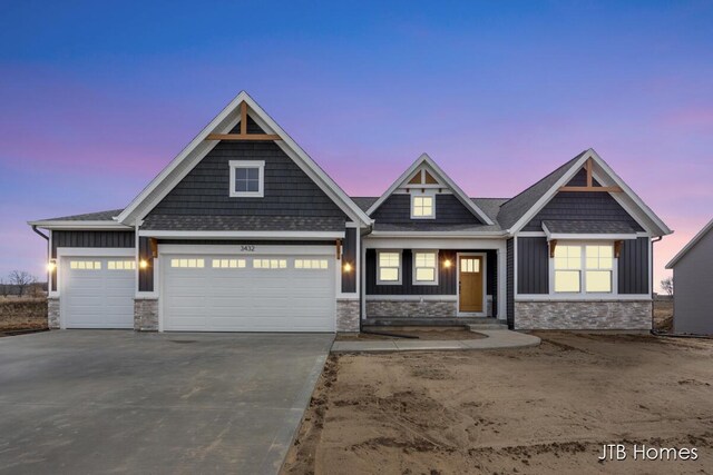 3432 Conrail Dr, Byron Center, MI 49315 - craftsman inspired home featuring stone siding, board and batten siding, driveway, and an attached garage