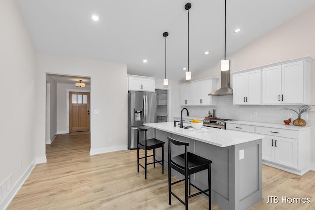 3432 Conrail Dr, Byron Center, MI 49315 - kitchen with appliances with stainless steel finishes, a sink, wall chimney range hood, tasteful backsplash, and a kitchen breakfast bar