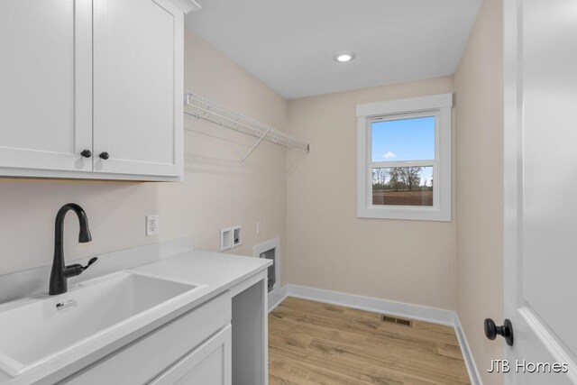 3432 Conrail Dr, Byron Center, MI 49315 - laundry room featuring cabinet space, baseboards, washer hookup, light wood-type flooring, and recessed lighting