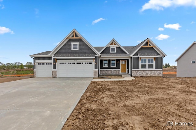 3432 Conrail Dr, Byron Center, MI 49315 - craftsman house featuring stone siding, board and batten siding, a garage, and driveway