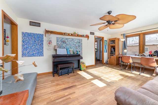 living room with light hardwood / wood-style floors and ceiling fan