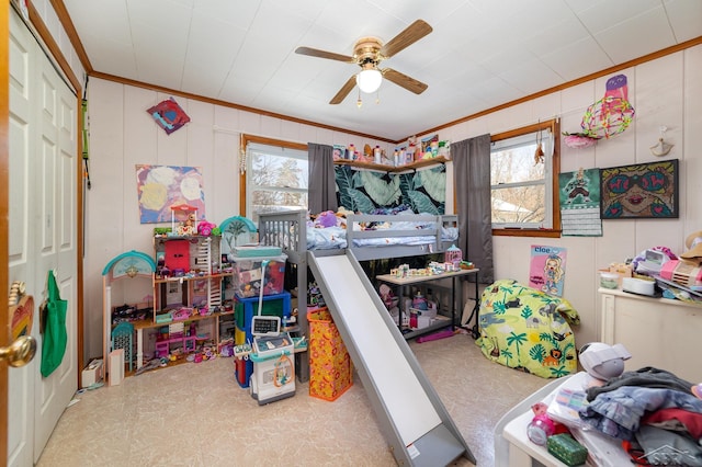 bedroom with ceiling fan, ornamental molding, a closet, and multiple windows