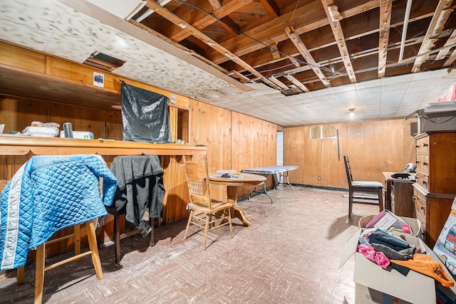 basement featuring wood walls