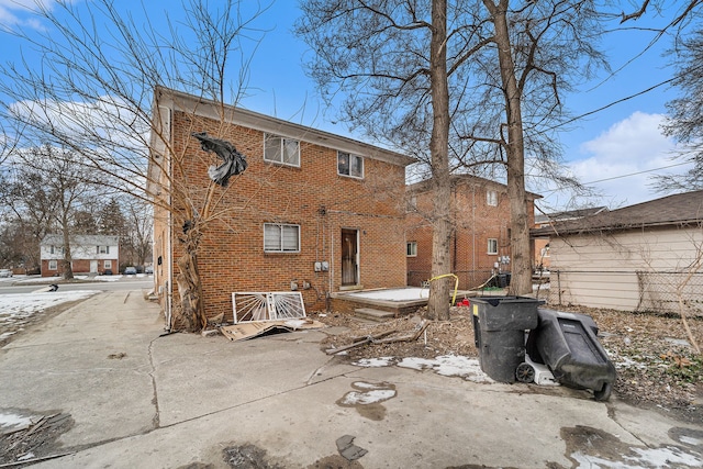 view of snow covered back of property