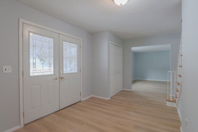 entryway with light wood-type flooring and french doors