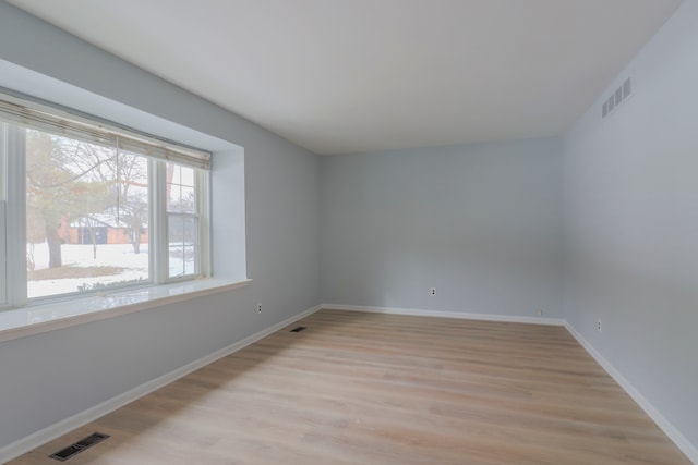 spare room with light hardwood / wood-style floors