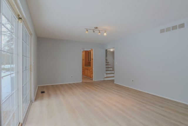 spare room featuring light hardwood / wood-style flooring