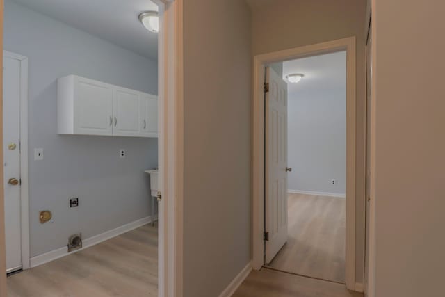 washroom with light hardwood / wood-style flooring, cabinets, and hookup for an electric dryer