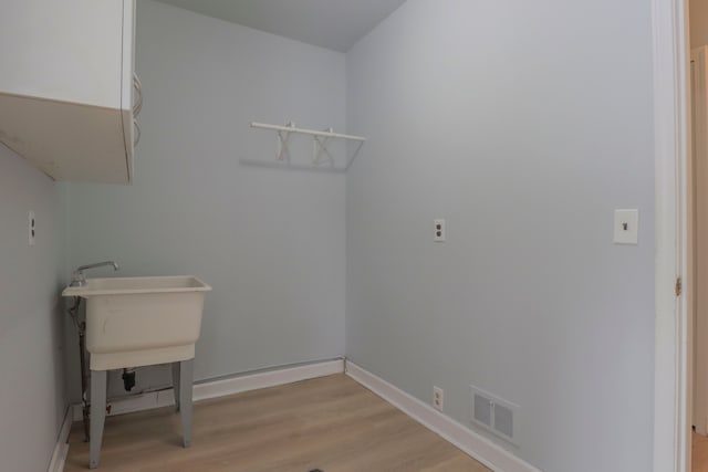 laundry room with light hardwood / wood-style floors