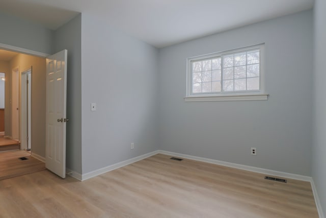 spare room with light hardwood / wood-style floors