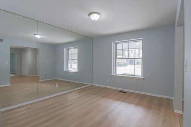 unfurnished room with light hardwood / wood-style flooring