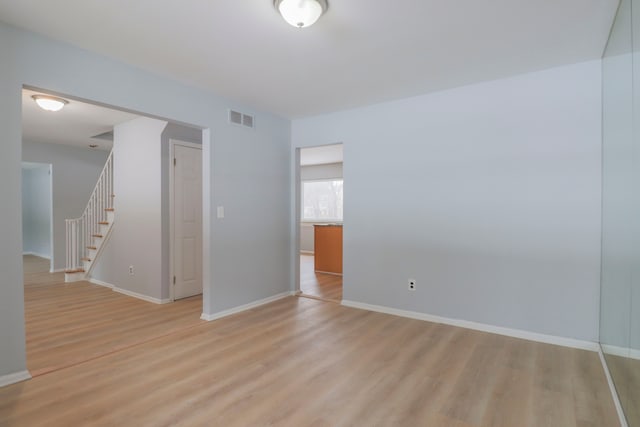 spare room with light wood-type flooring