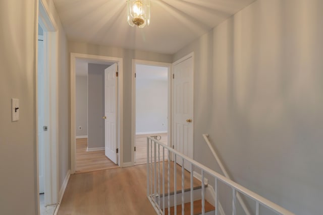 hallway with light hardwood / wood-style flooring