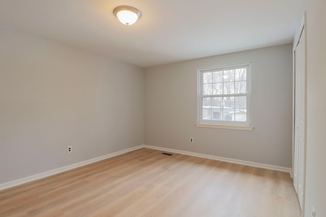 spare room featuring light hardwood / wood-style flooring