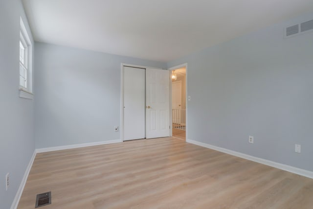 spare room featuring light wood-type flooring