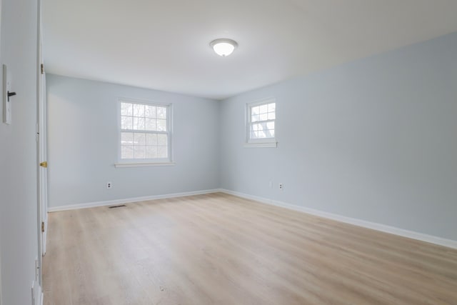 empty room with light hardwood / wood-style floors