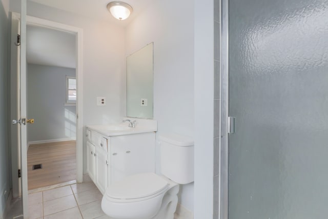 bathroom with an enclosed shower, vanity, tile patterned floors, and toilet