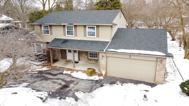 view of property with a garage and a porch