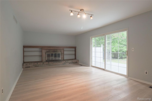 6868 Vachon Dr, Bloomfield Hills, MI 48301 - unfurnished living room with baseboards, light wood-type flooring, and a fireplace