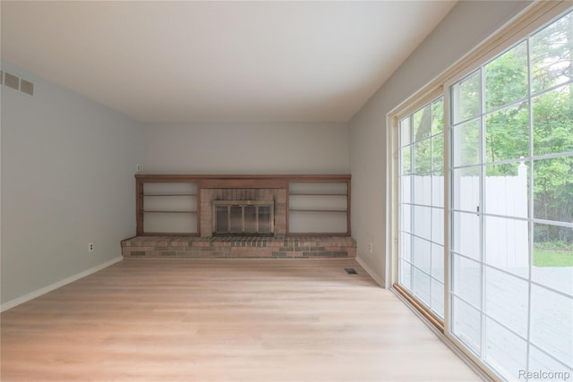 6868 Vachon Dr, Bloomfield Hills, MI 48301 - unfurnished living room with light wood-style floors, baseboards, and a brick fireplace