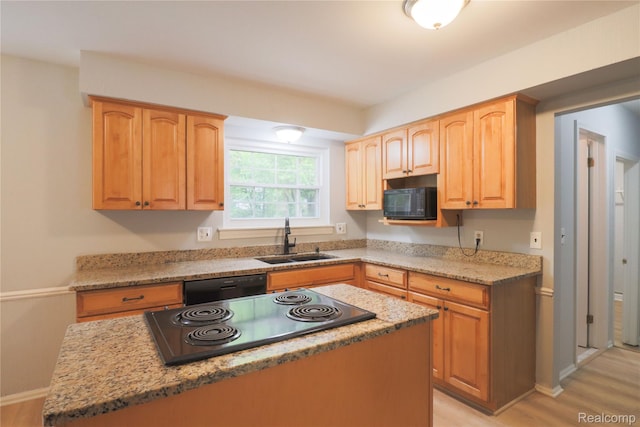 6868 Vachon Dr, Bloomfield Hills, MI 48301 - kitchen with a sink, black appliances, baseboards, light wood-style flooring, and a kitchen island