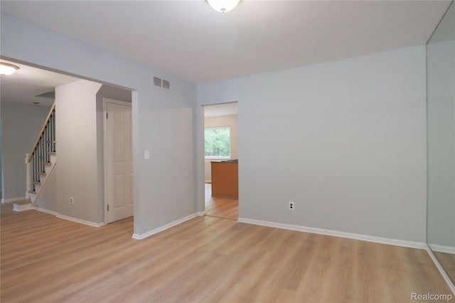 6868 Vachon Dr, Bloomfield Hills, MI 48301 - spare room with light wood-style flooring, stairway, and baseboards