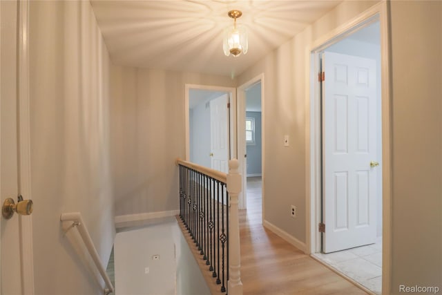 6868 Vachon Dr, Bloomfield Hills, MI 48301 - hallway with an upstairs landing, light wood-type flooring, and baseboards