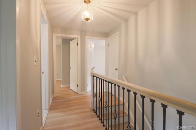 6868 Vachon Dr, Bloomfield Hills, MI 48301 - corridor featuring light wood finished floors, an upstairs landing, and baseboards