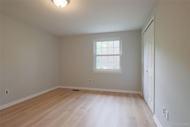 6868 Vachon Dr, Bloomfield Hills, MI 48301 - unfurnished bedroom with light wood-type flooring, a closet, and baseboards