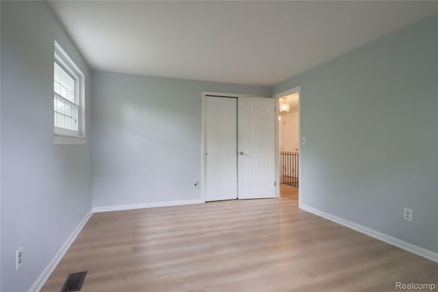 6868 Vachon Dr, Bloomfield Hills, MI 48301 - unfurnished bedroom with light wood-style floors, baseboards, and a closet