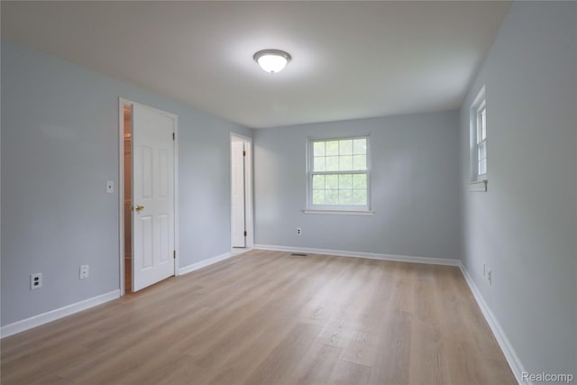 6868 Vachon Dr, Bloomfield Hills, MI 48301 - unfurnished room with light wood-style flooring, plenty of natural light, and baseboards