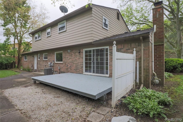 6868 Vachon Dr, Bloomfield Hills, MI 48301 - rear view of property featuring a chimney, brick siding, and a wooden deck
