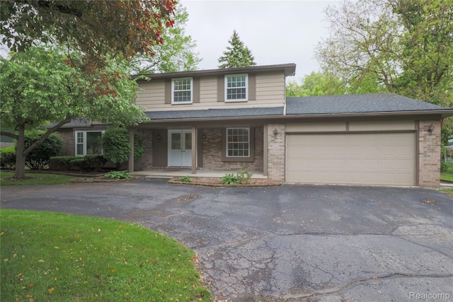 6868 Vachon Dr, Bloomfield Hills, MI 48301 - traditional-style home with asphalt driveway, brick siding, an attached garage, and a porch
