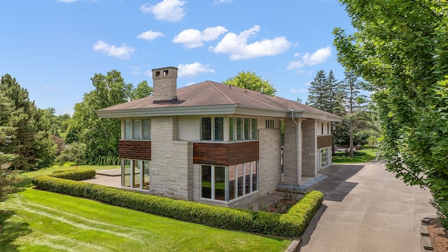 rear view of house featuring a lawn