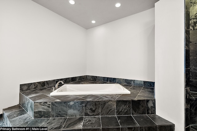 bathroom featuring tiled bath