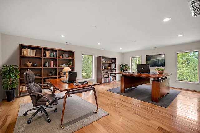 office space with light hardwood / wood-style flooring