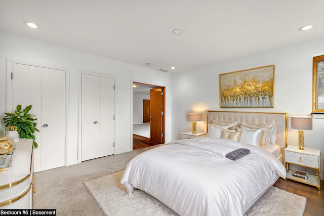 carpeted bedroom featuring two closets