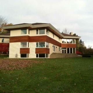 rear view of property with a lawn