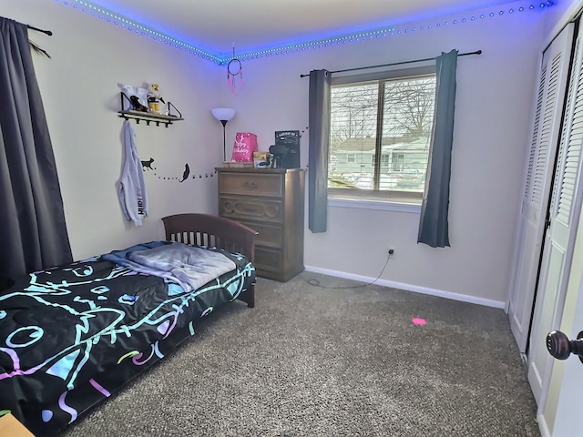 bedroom with dark carpet and a closet