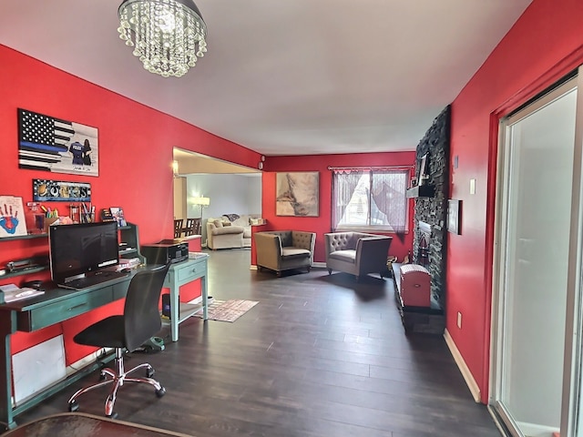 office space featuring an inviting chandelier and dark wood-type flooring